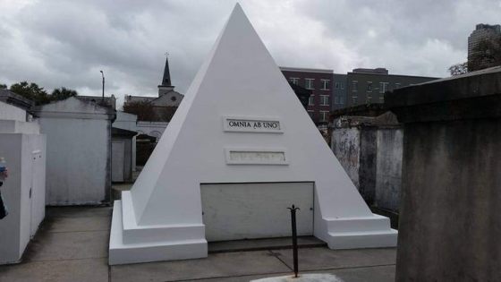 A black & white photograph of a pyramid-shaped tomb built in New Orleans by the actor Nicolas Cage